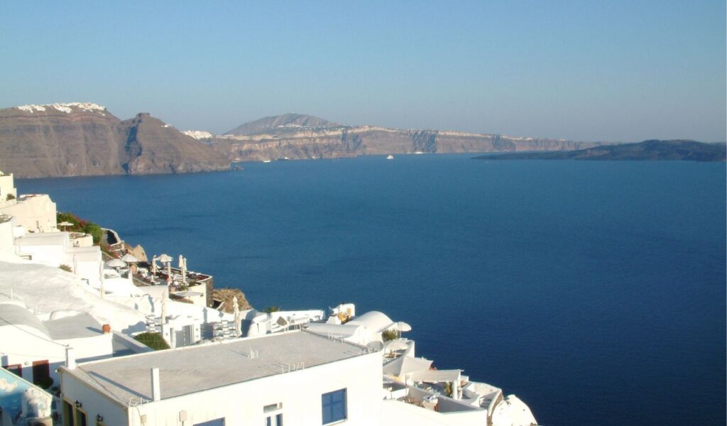 Whitewashed buildings overlooking the Aegean Sea in Santorini, Greece—famous for romantic views and volcanic cliffs.