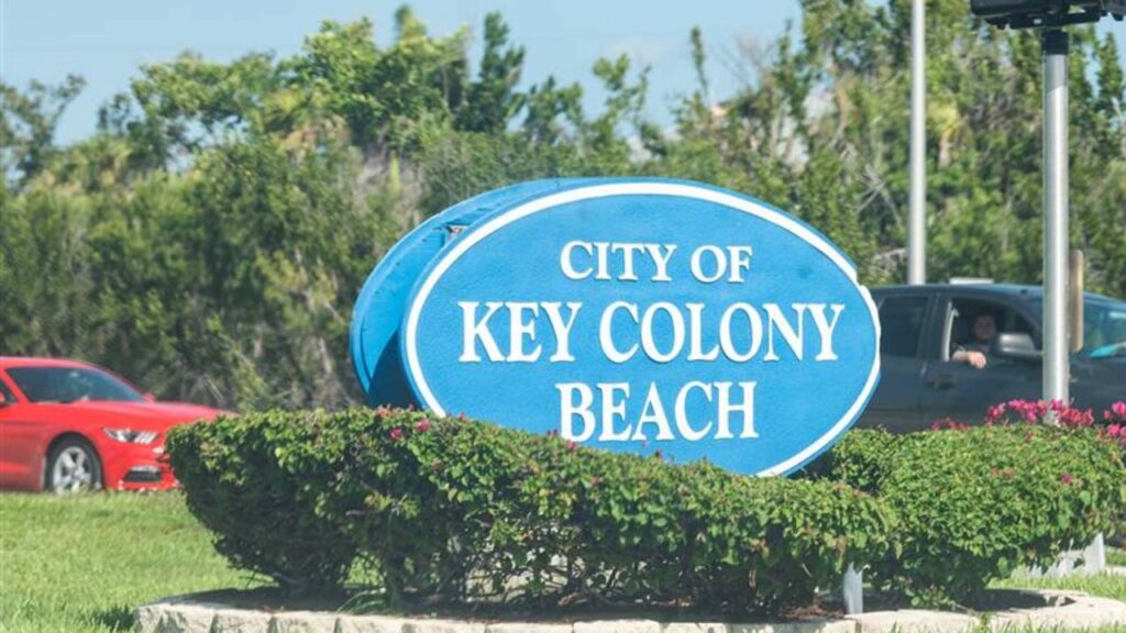 Key Colony Beach, USA - May 1, 2018: Closeup of blue and white sign of city at Florida keys in summer on sunny day