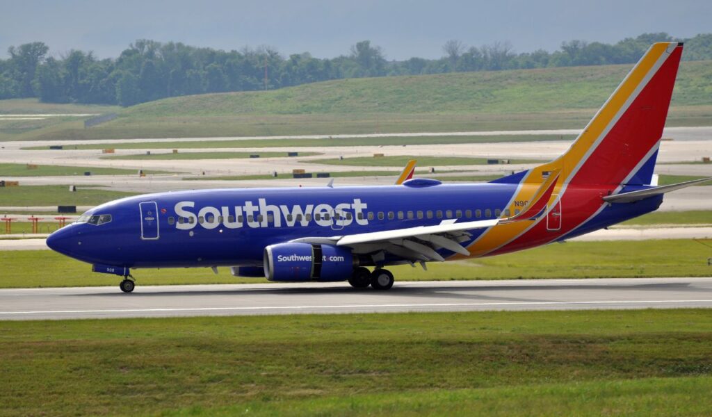 Southwest Airlines jet taxis on the runway, showcasing its bold blue, red, and yellow livery.