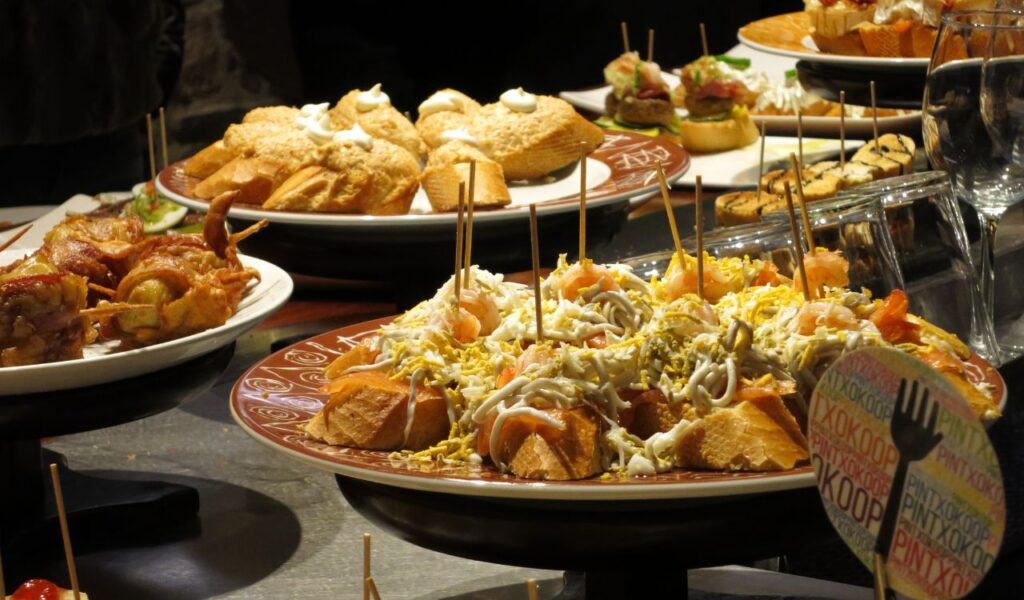 Colorful Spanish tapas on display at a lively bar—small bites perfect for a romantic and flavorful date night in Spain.