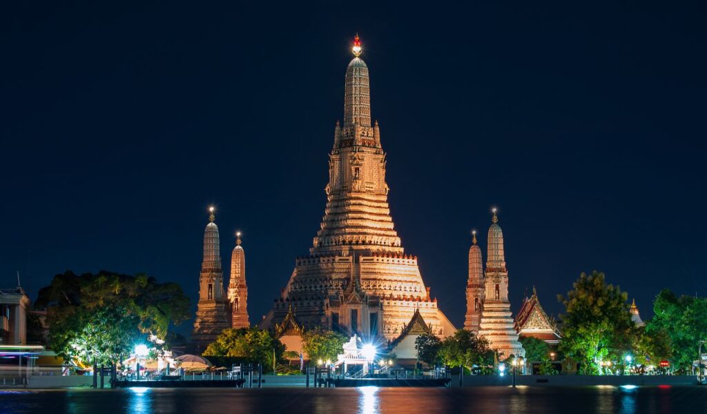 Wat Arun temple in Bangkok, Thailand, illuminated at night