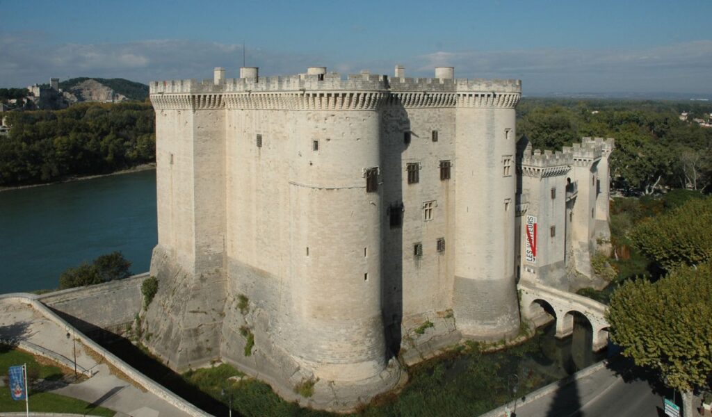 Massive stone castle-like building by a river in Provence, France—mistakenly labeled as The Old Schoolhouse stay.