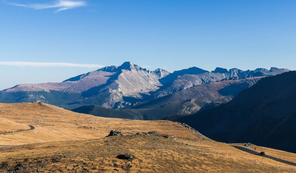 Trail Ridge Road winding through alpine tundra with Rocky Mountain peaks in the background.