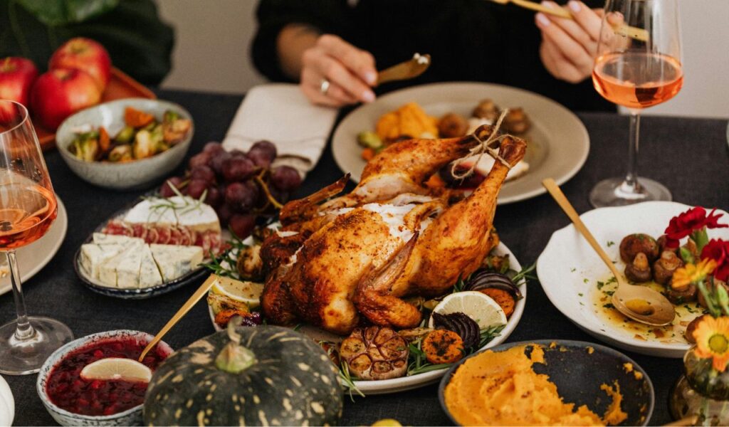Romantic dinner setup featuring roasted chicken, wine, and sides—perfect for cozy date nights in Turkey or Mediterranean homes.