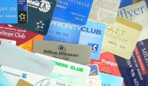Assorted airline and hotel loyalty program cards arranged in an overlapping pile, showing various rewards memberships.