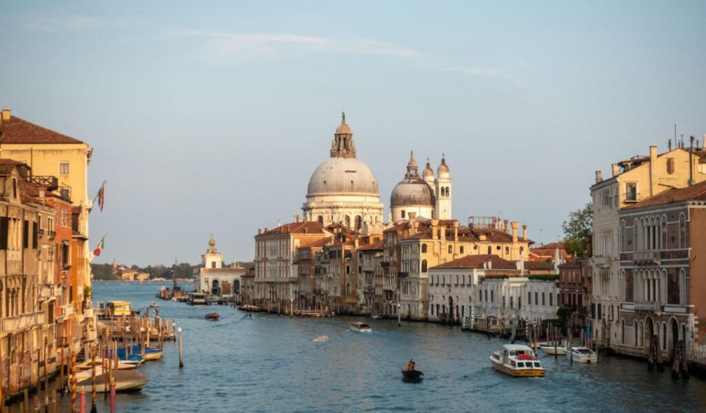Grand Canal in Venice with boats and Santa Maria della Salute basilica.
