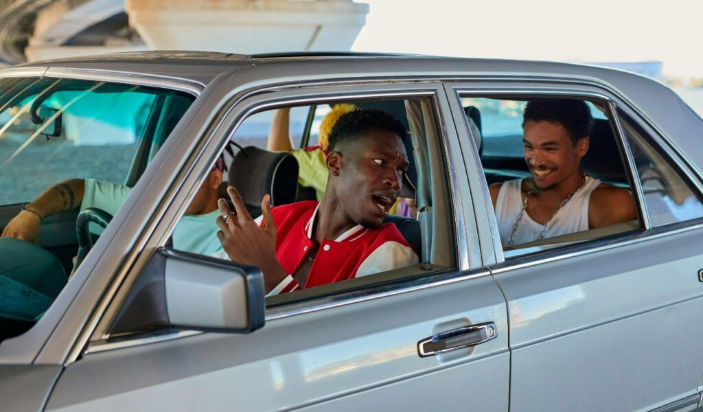 Friends enjoying music and conversation during a road trip, creating fun memories inside the car.