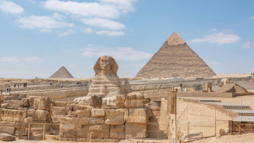 The Great Sphinx and Pyramids of Giza under a clear sky, symbolizing Egypt’s ancient wonders and rich heritage.