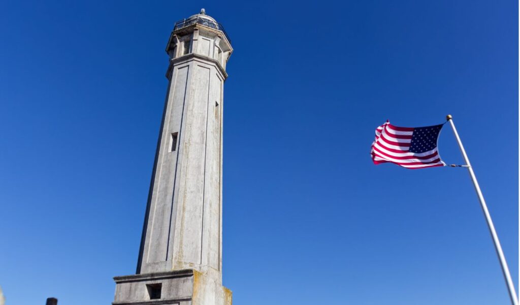American Flag flapping in the wind on Alcatraz Island Light House, San Francisco, California