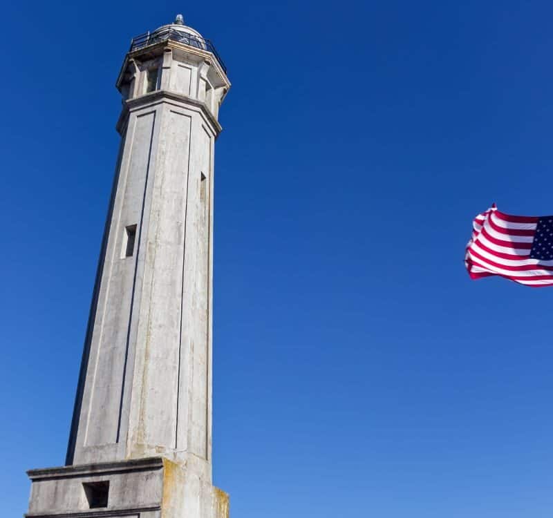 American Flag flapping in the wind on Alcatraz Island Light House, San Francisco, California