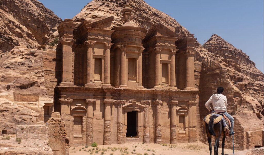 Boy on a horse admiring the ruins of Petra, Jordan