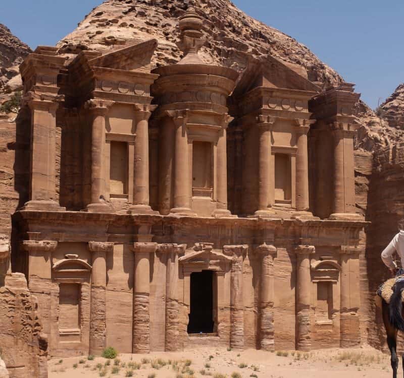 Boy on a horse admiring the ruins of Petra, Jordan