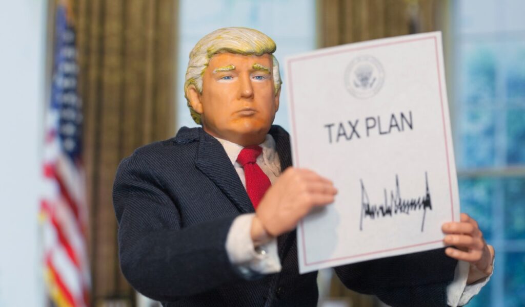 Caricature of United States President Donald Trump holding up an executive order that states Tax Plan, which was signed as a partisan Republican law