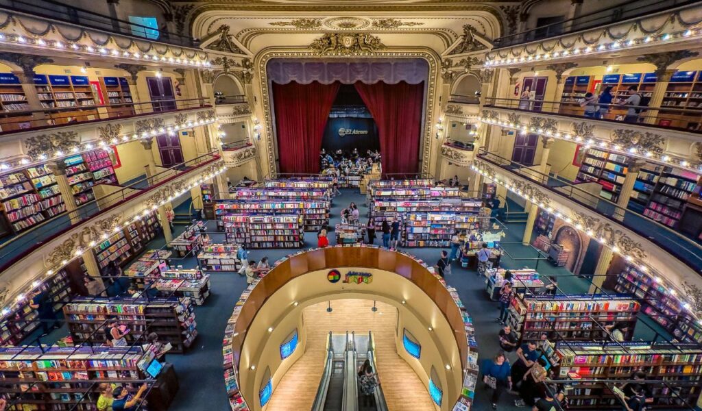 Interior of El Ateneo Grand Splendid bookstore in Buenos Aires, featuring ornate balconies, bookshelves, and a stage with red curtains.
