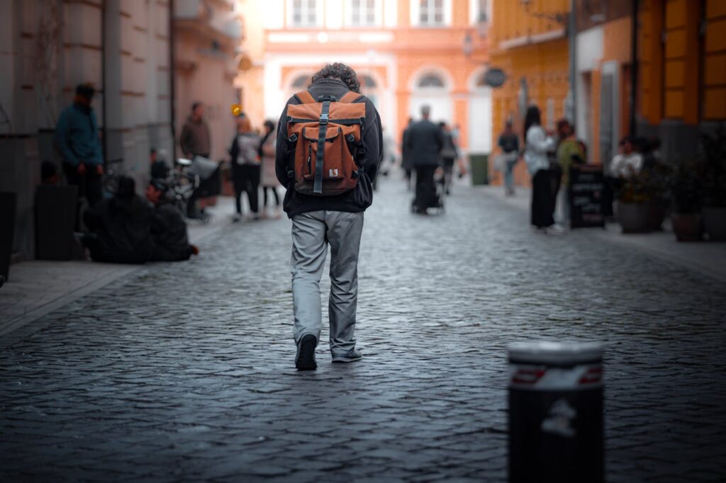 traveler with backpack on cobblestone street