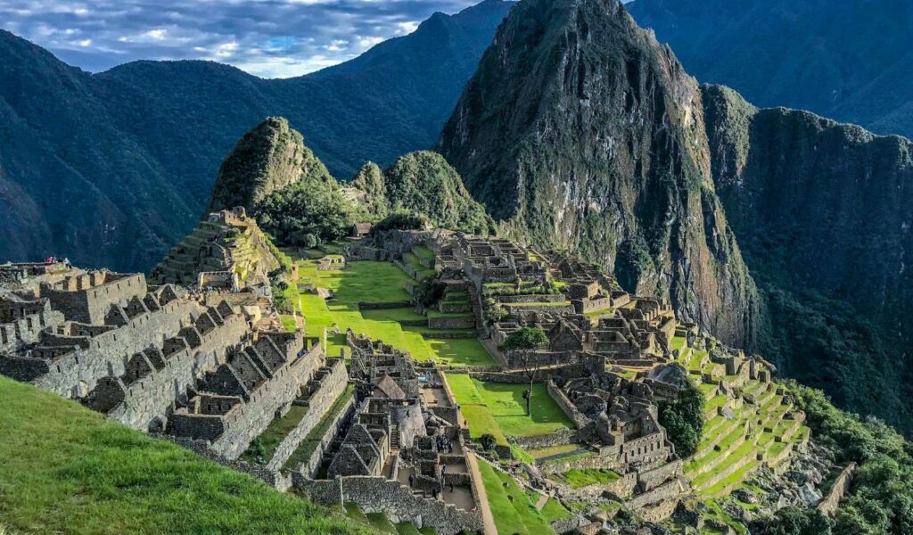 Machu Picchu in Peru, an ancient Incan city nestled high in the Andes, with terraced stone structures and lush green mountain scenery.