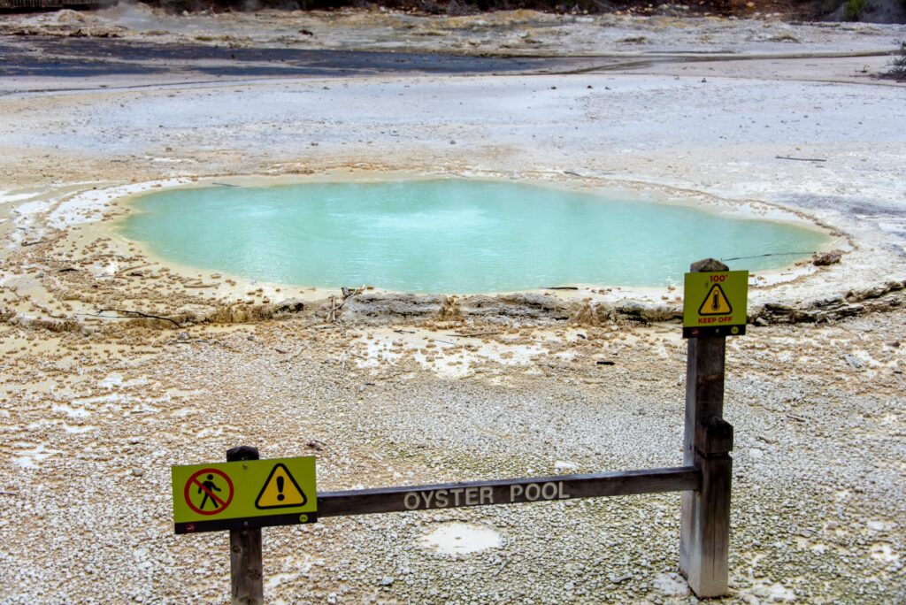 Yellowstone hot spring boardwalk with warning sign