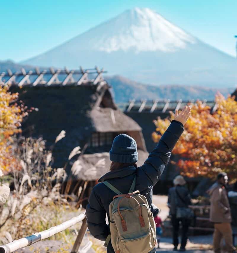 Woman tourist with mount Fuji at Saiko Iyashino Sato Nenba in Autumn season, happy Traveler travel Mt Fuji, Yamanashi, Japan. Landmark for tourist attraction. Japan Travel, Destination and Vacation