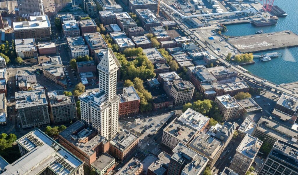 Aerial view of downtown Port Townsend, Washington, showing historic brick buildings, the waterfront, and the iconic Smith Tower.
