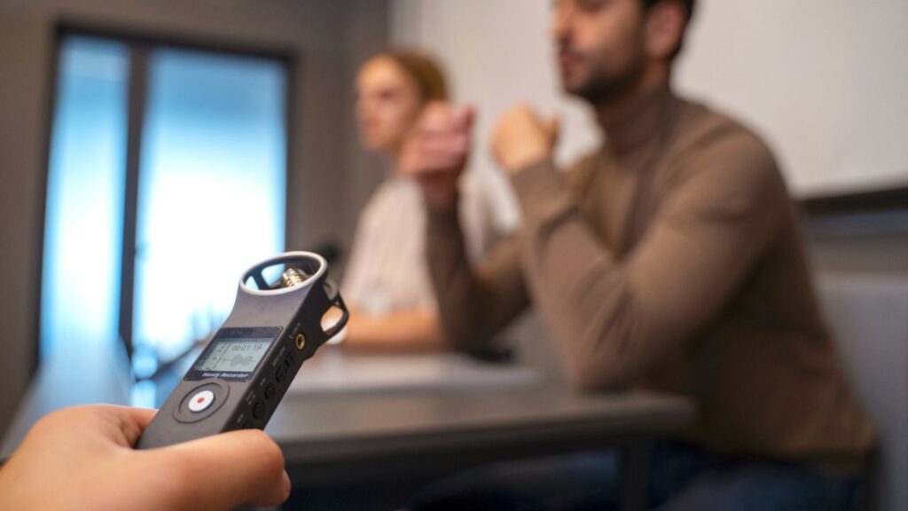 Handheld bug detector scanning hotel room