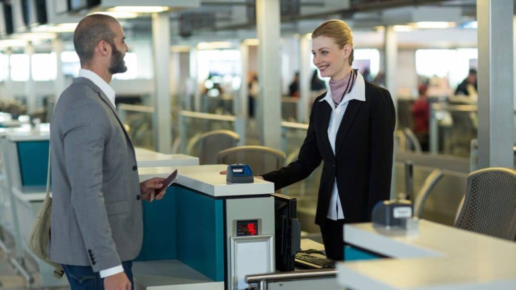 Airline staff gate agent checking passport boarding pass”