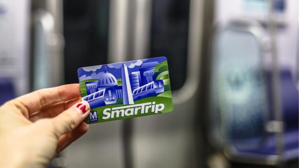 Washington, DC - March 31, 2018: A woman holds a SmarTrip metro card while underground in the Metrorail system.