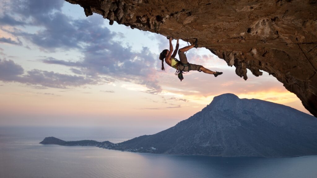 Young female rock climber at sunset, Kalymnos Island, Greece