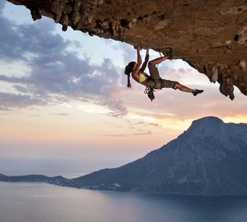 Young female rock climber at sunset, Kalymnos Island, Greece