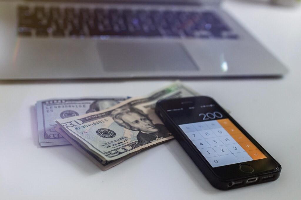 Traveler budgeting trip with calculator