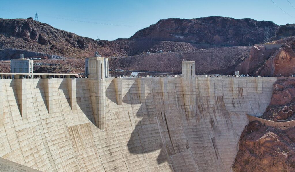 Close-up view of Hoover Dam’s massive concrete wall with intake towers and surrounding rocky terrain.
Ask ChatGPT
Ask ChatGPT