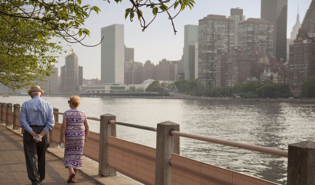 older couple walking along park path