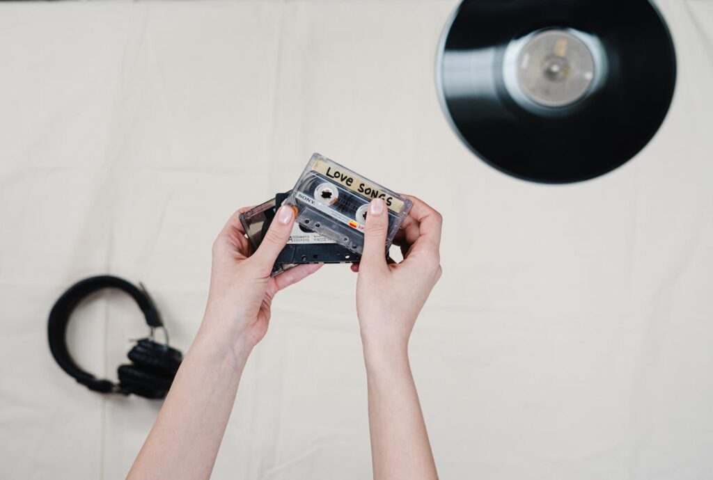 Hand selecting cassette tape from a box of tapes