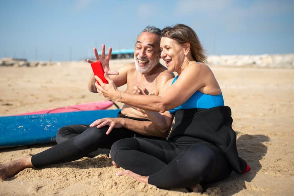 Elderly Woman Taking Selfie with an Elderly Man at the Beach Retires