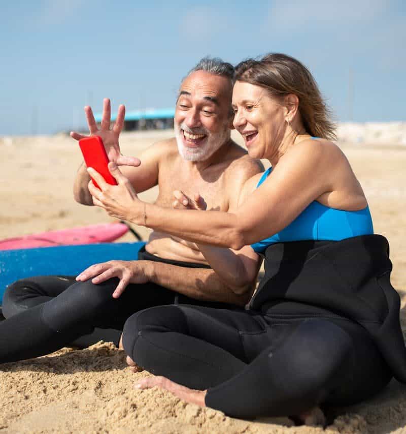 Elderly Woman Taking Selfie with an Elderly Man at the Beach Retires