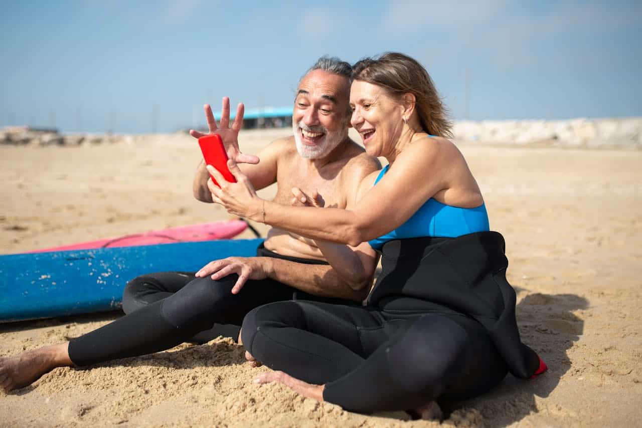 Elderly Woman Taking Selfie with an Elderly Man at the Beach Retires