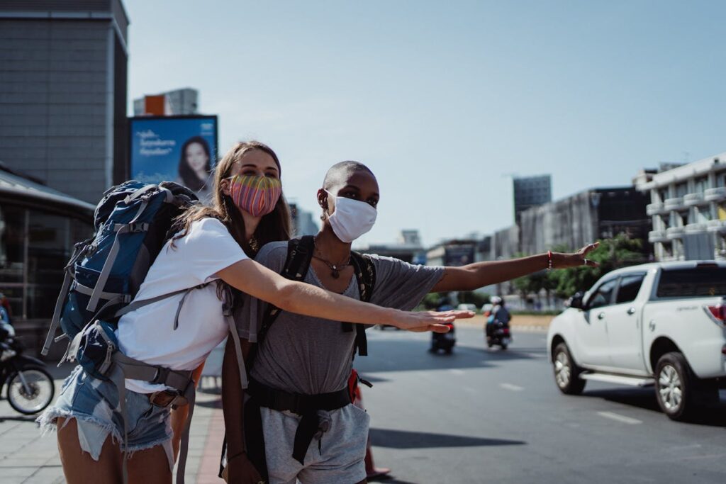 girls waving thier hand for a taxi