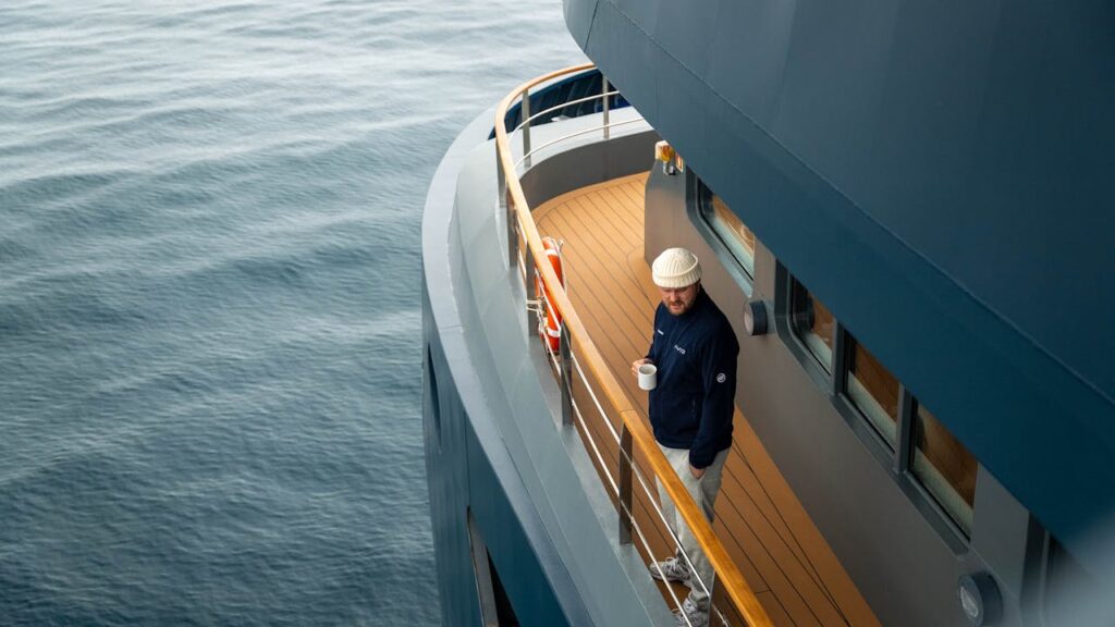 Solo traveler enjoying coffee on cruise balcony