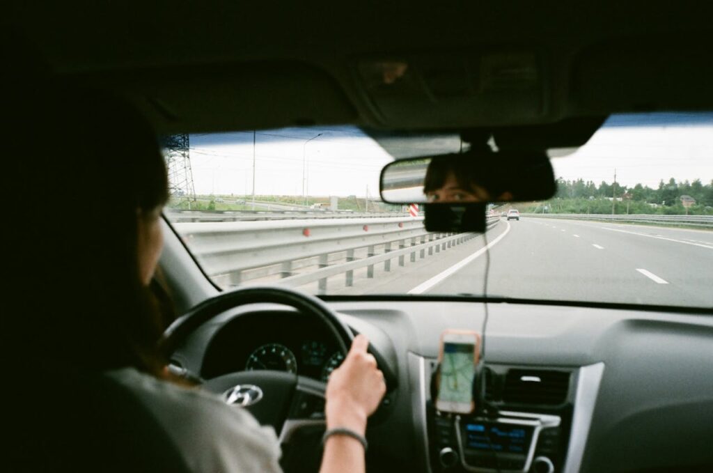 sunny road view from windshield with cassette in focus