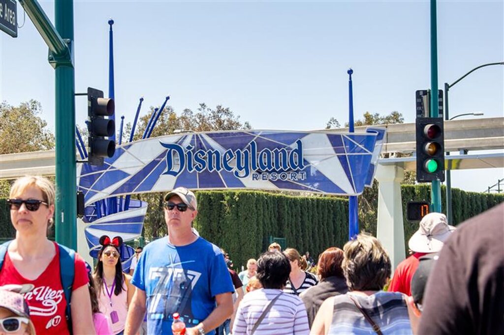 Anaheim, California/United States - 04/24/2019: Tourist walk across the street towards Disneyland theme park