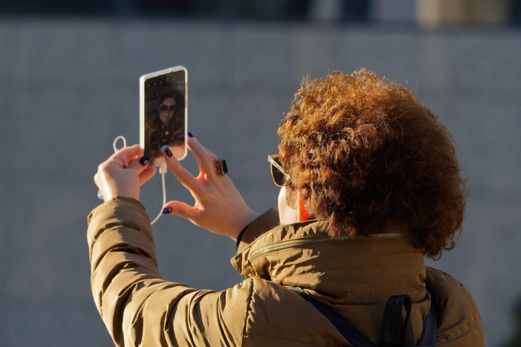 Women using WhatsApp video call abroad