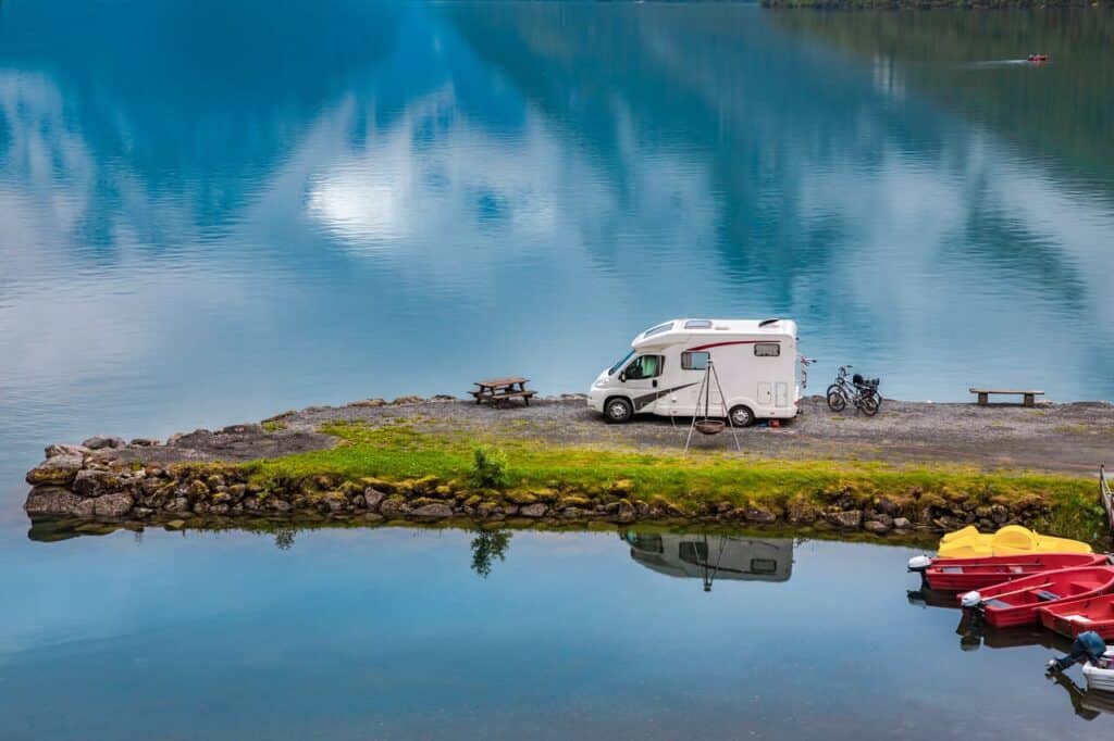 Scenic RV campground with multiple rigs parked by a lake