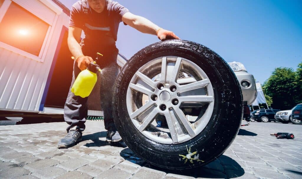 RV owner checking tire pressure or changing a tire