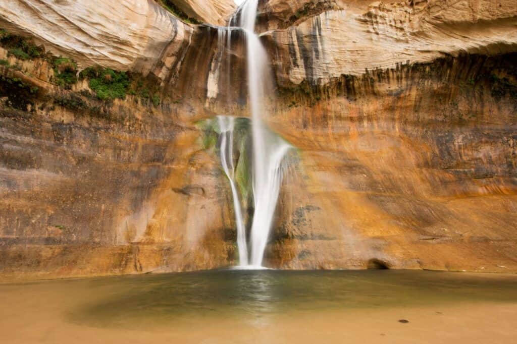 The waterfall plunging into its clear pool