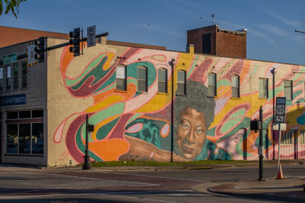 Colorful Street Art Mural on Brick Building in Urban Area