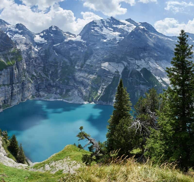 Panoramic view of Oeschinensee with Blüemlisalp, Fründenhorn and Doldenhorn (from Heuberg) Lake Oeschinen, Kandersteg (Switzerland)