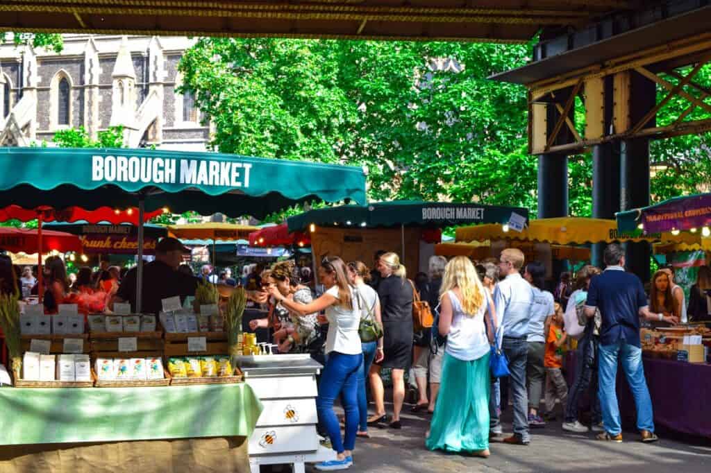 A bustling farmers’ market showing both locals and visitors mingling.