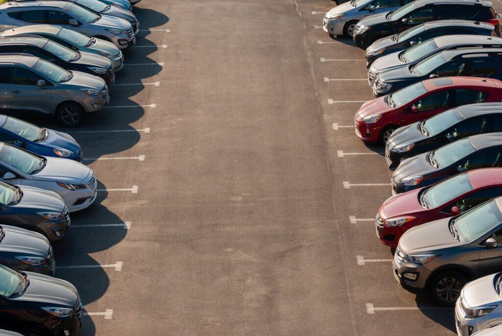 Rental car lot with vehicles lined up.
