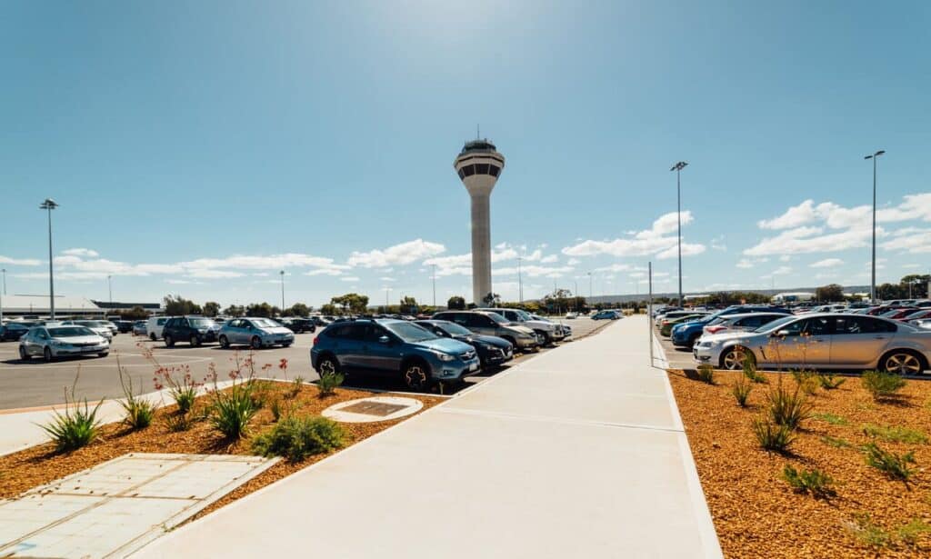 Rental cars lined up at an airport lot.