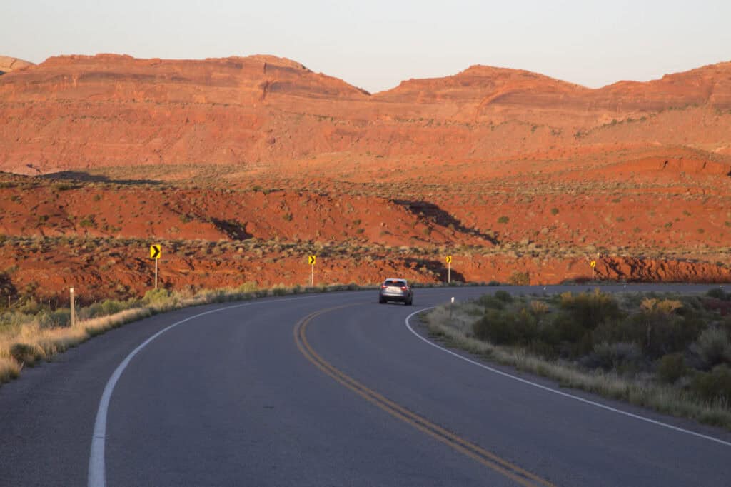 Car driving through a red rock canyon