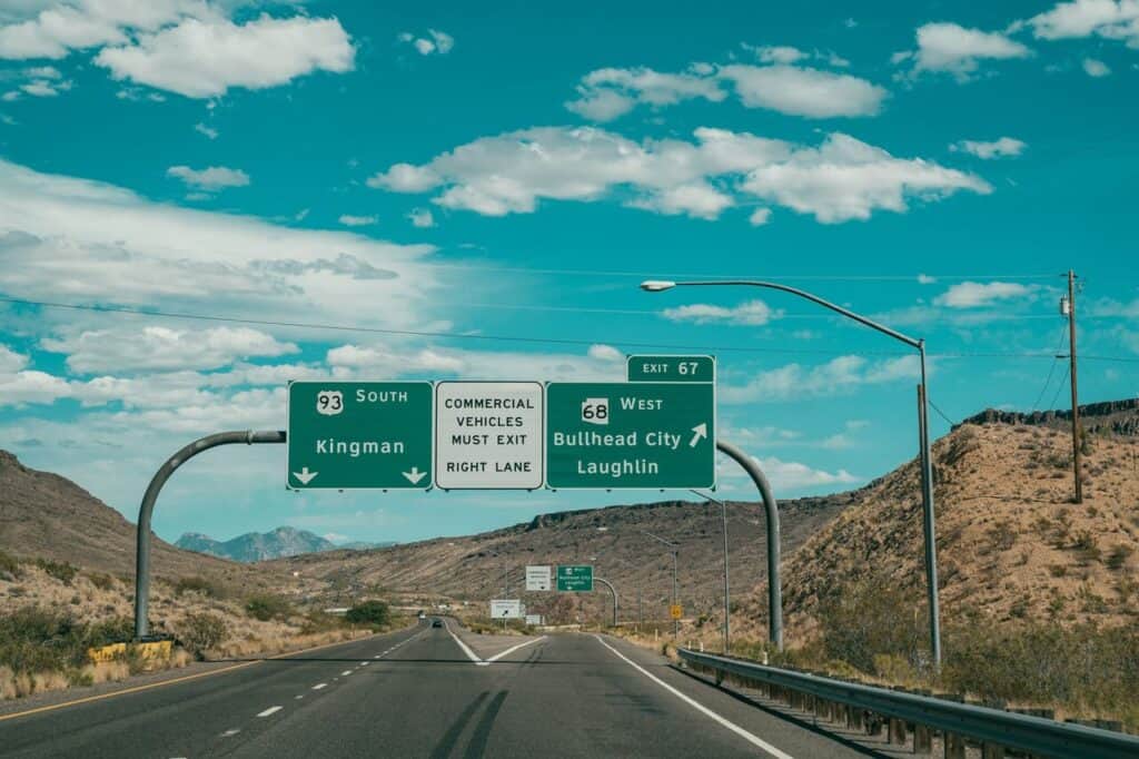 Roadside directional signs with distances listed.